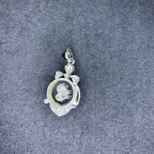 Spinning silver tone pendant